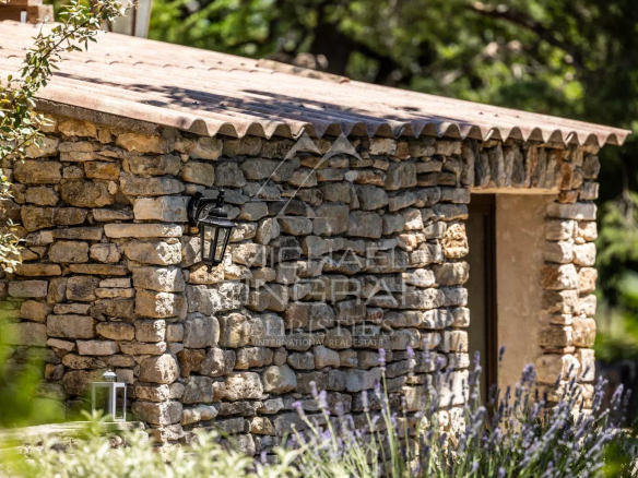 Stone outbuilding with lantern in a wooded park, near Gordes, Luberon.