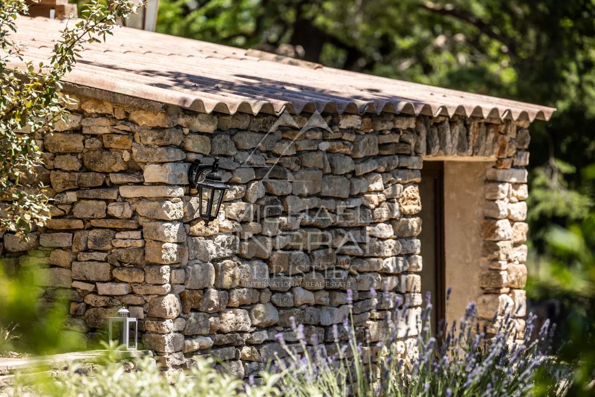 Stone outbuilding with lantern in a wooded park, near Gordes, Luberon.