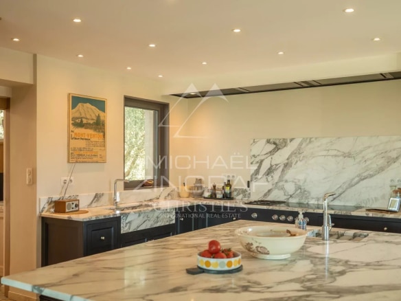 Modern kitchen with marble worktop and high-end appliances in a Provençal house.