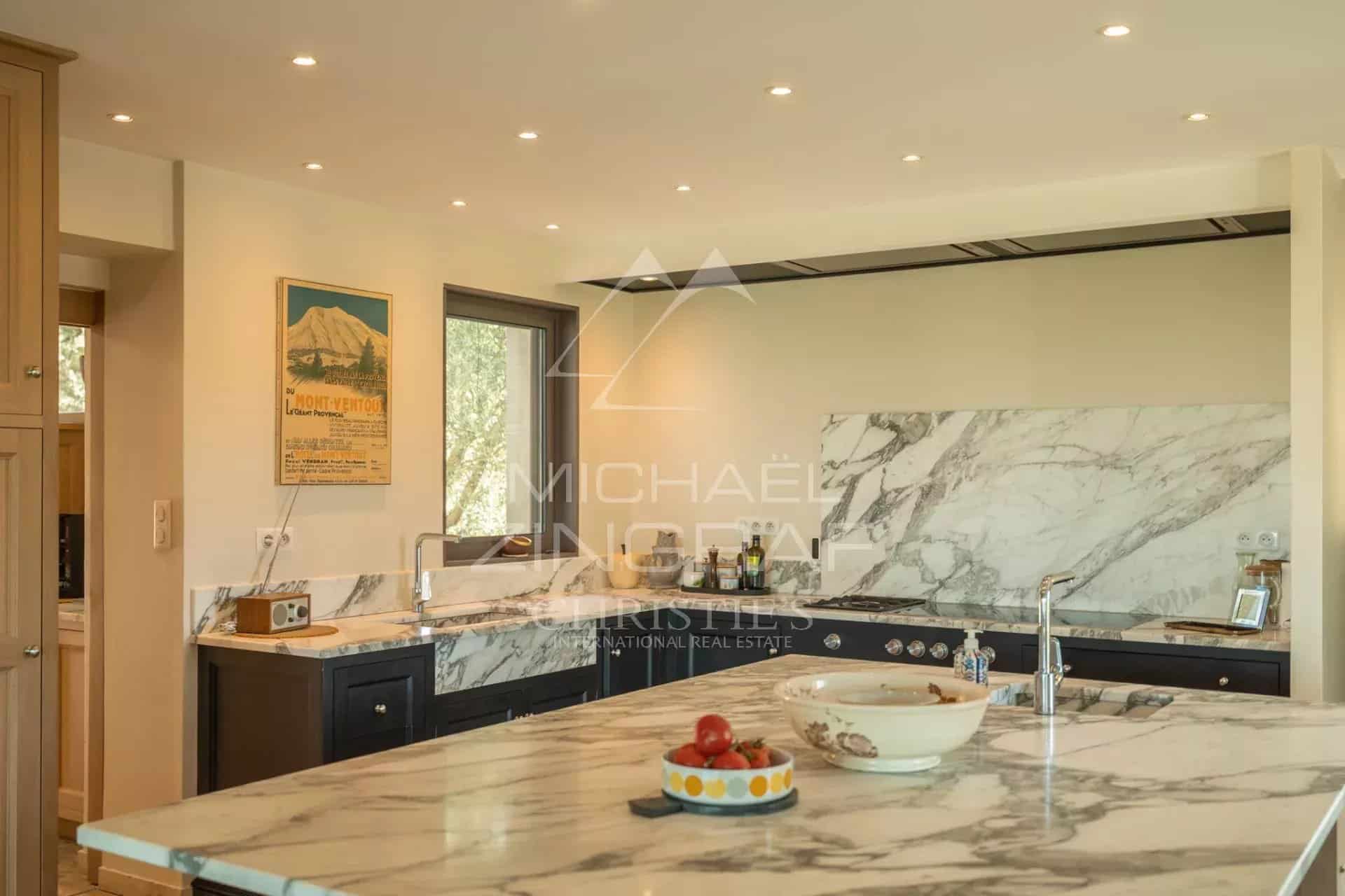 Modern kitchen with marble worktop and high-end appliances in a Provençal house.