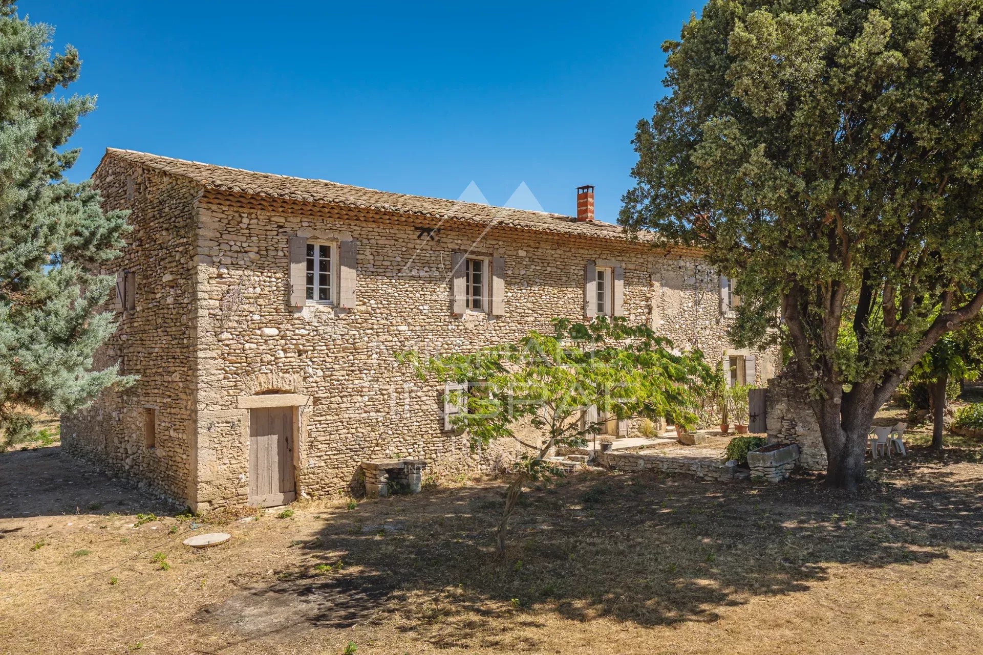 Mas en pierre du XVIIIe siècle à rénover, situé à Gordes, vue sur le Luberon.