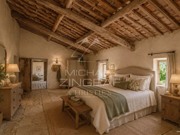 Chambre d'un mas XVIIIe à rénover, avec plafond en bois et murs en pierre, vue sur la campagne provençale.