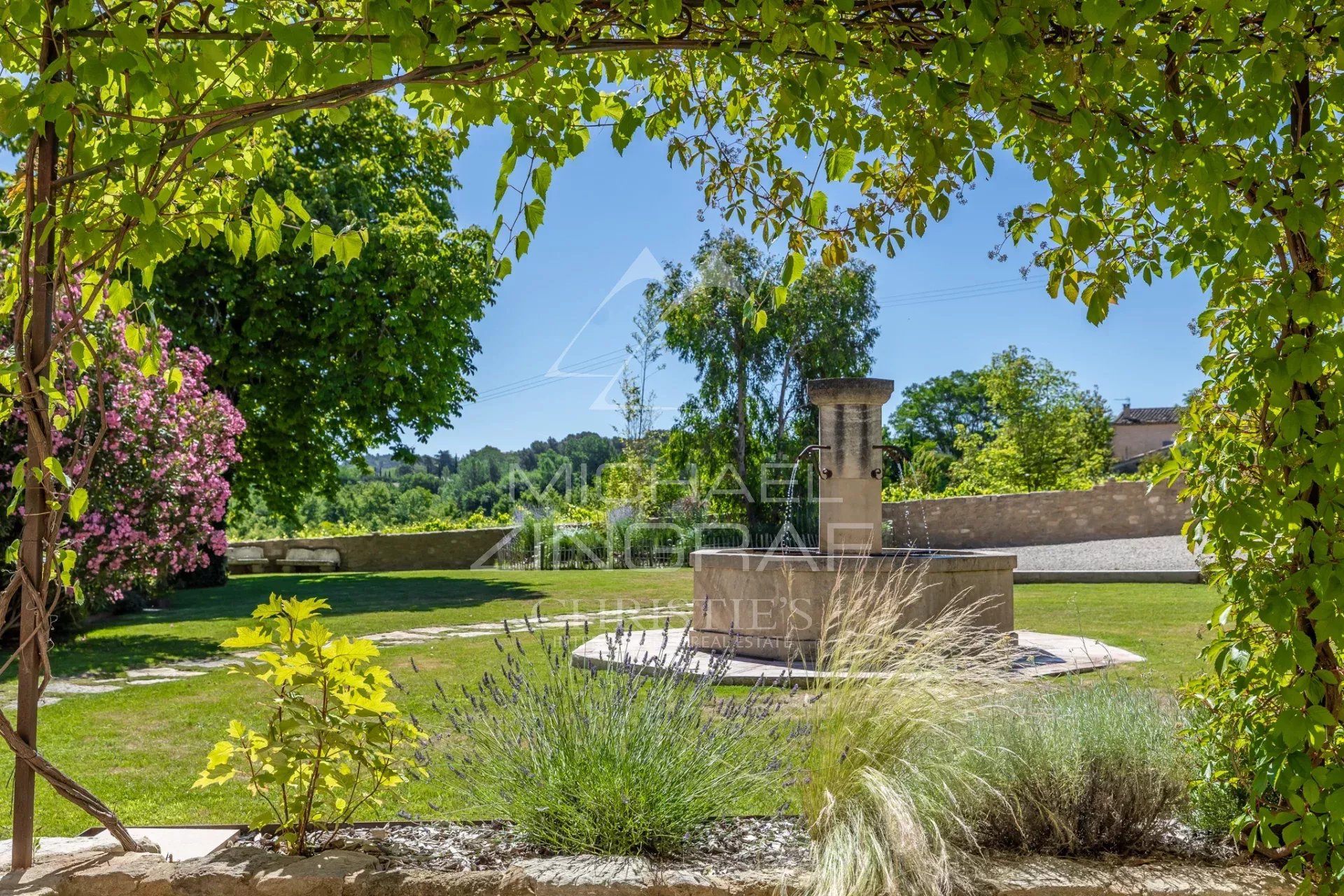 Garden of a renovated farmhouse in Oppède Garden of a renovated farmhouse in Oppède with a fountain and Mediterranean plants.