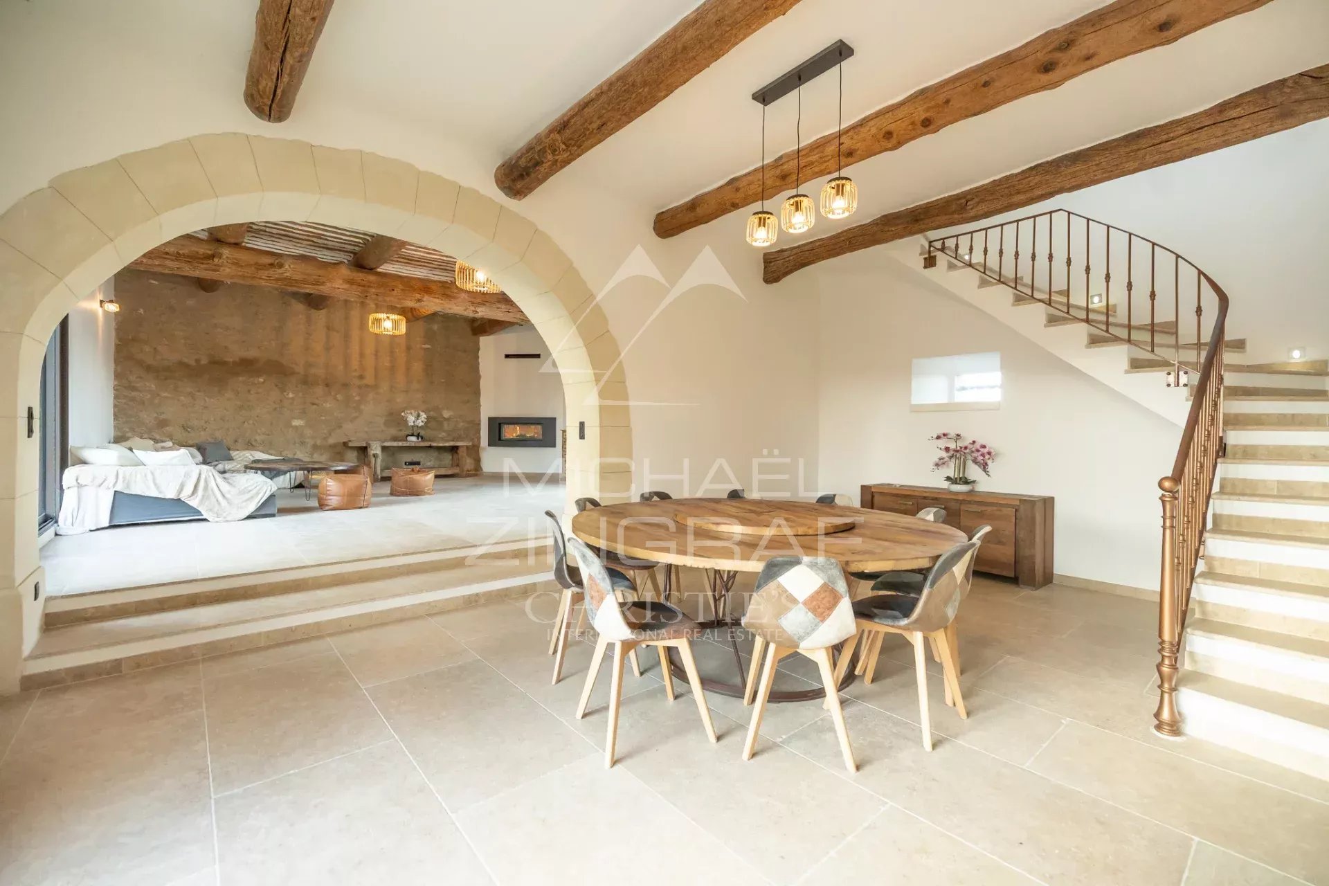 Interior of a renovated farmhouse in Oppède Interior of a renovated farmhouse with living room and dining room, exposed beams and staircase.
