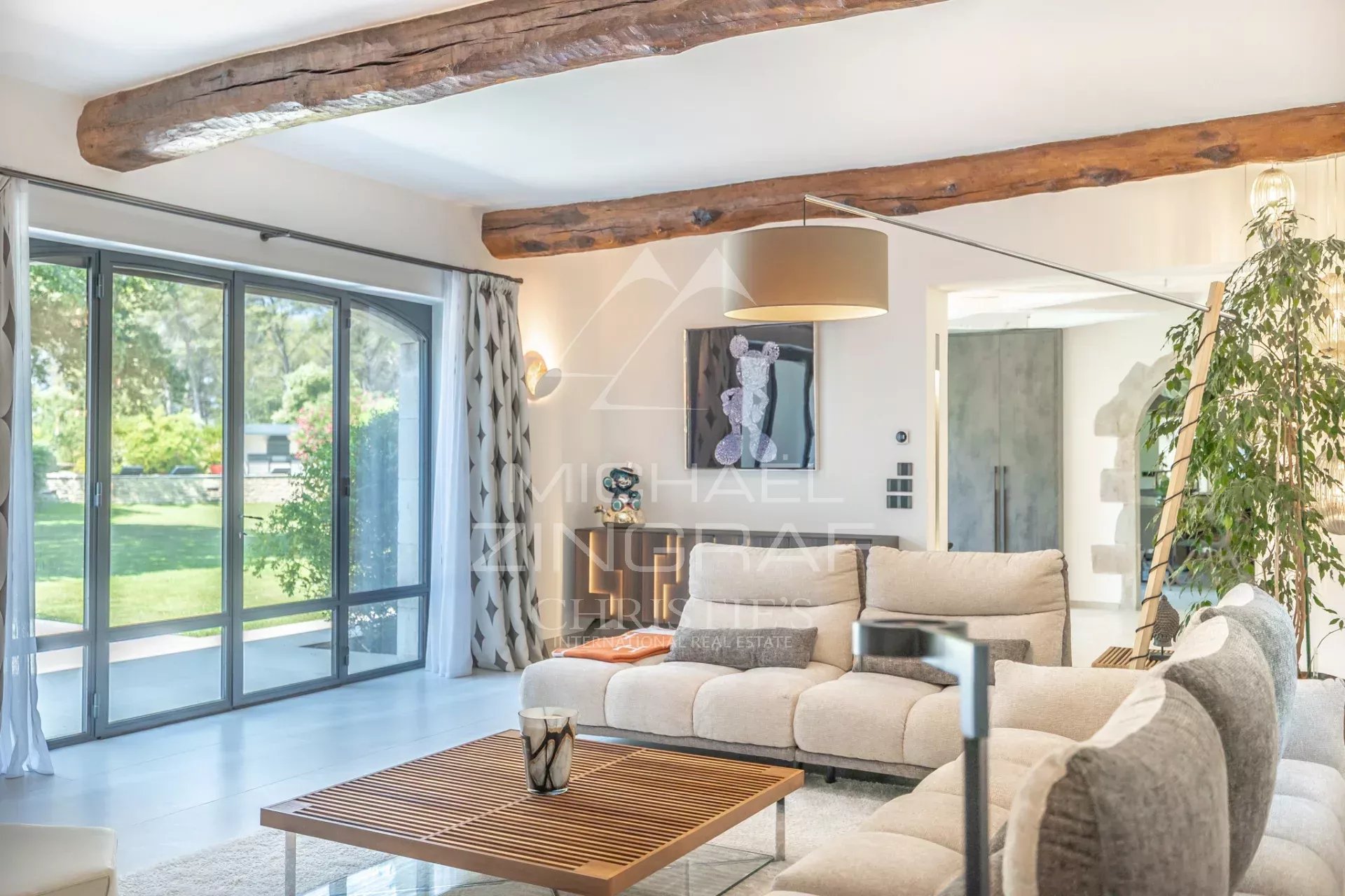 Interior of a modern house Interior of a modern house with a bright living room and large bay windows, decorated with contemporary elements.