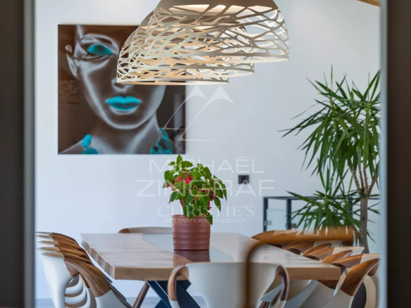 Interior of a modern house with a dining table and contemporary decor.