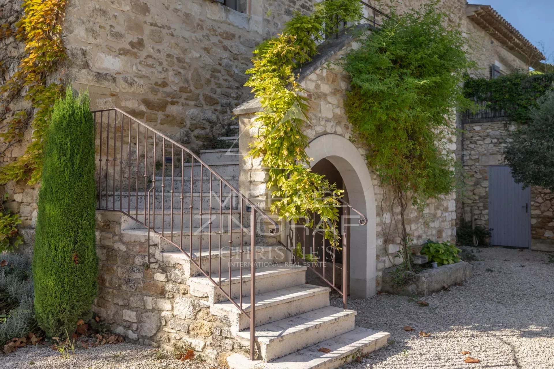 Stone staircase in Oppède Stone staircase leading to a stone building with climbing plants in Oppède.