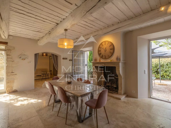 Interior of a Provençal farmhouse with dining room, fireplace and natural light.