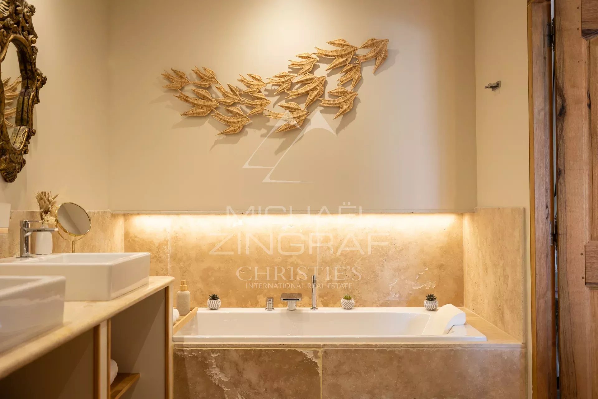 Elegant bathroom Bathroom with bathtub and wooden decor, soft lighting.
