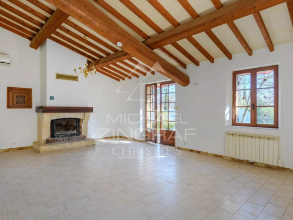 Interior of a villa to be renovated with exposed beams and fireplace, located in Gordes.