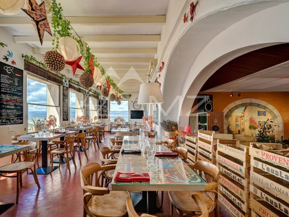 Intérieur d'un restaurant d'hôtel avec décoration chaleureuse et vue panoramique sur le Luberon.