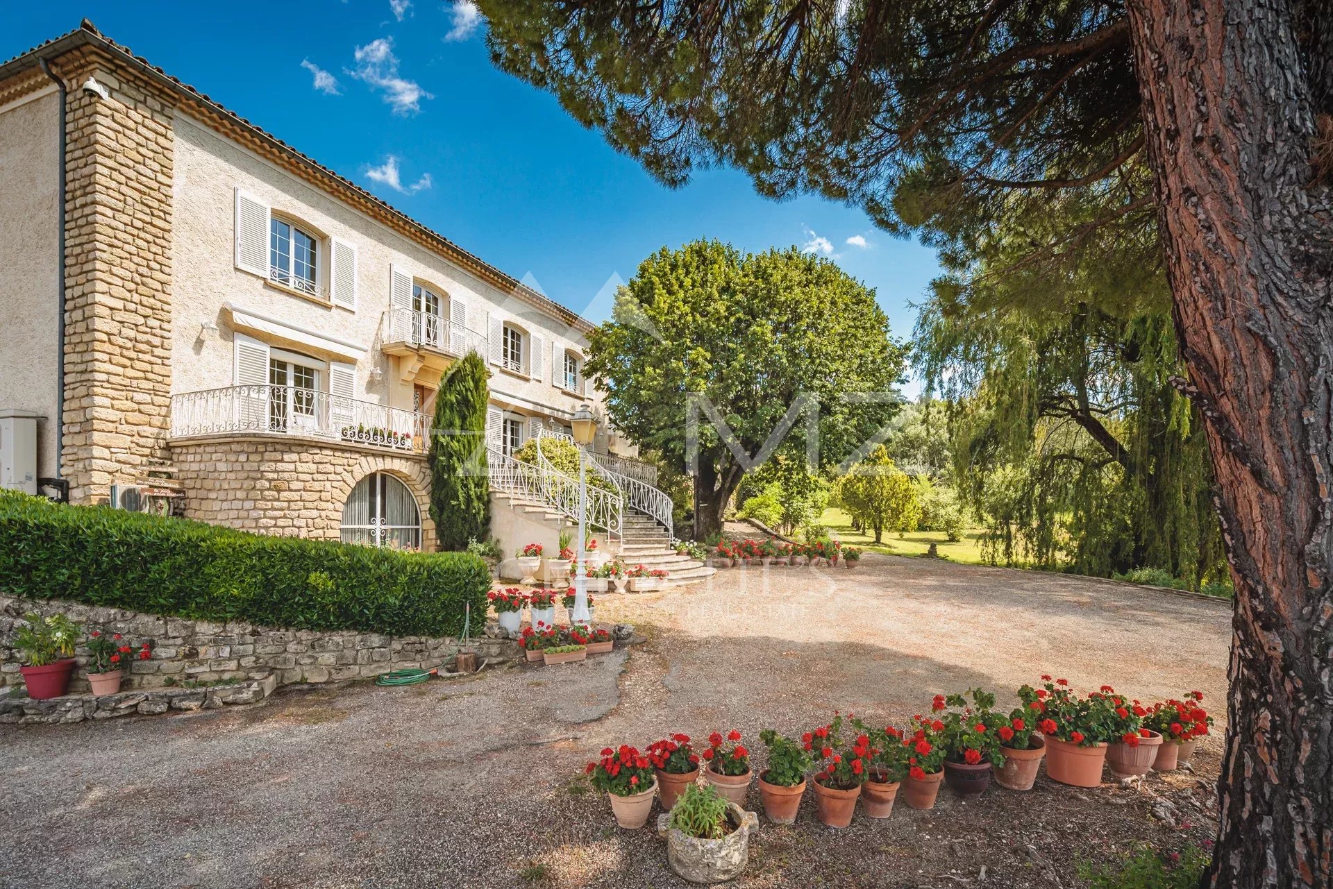 Belle demeure avec jardin et piscine Demeure en pierre avec jardin fleuri et arbres, vue panoramique sur la nature.