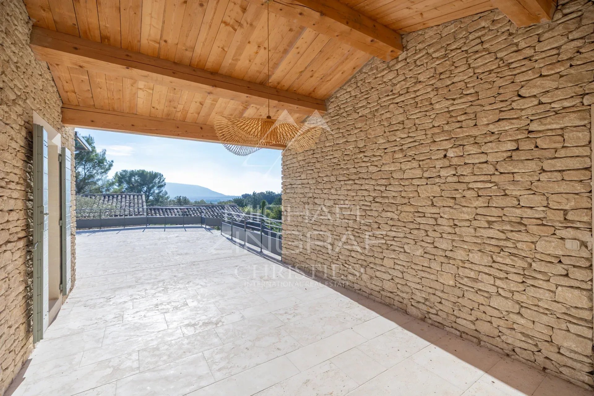 Terrace of a contemporary villa in Gordes Terrace of a contemporary villa in Gordes with views of the Provençal landscape.