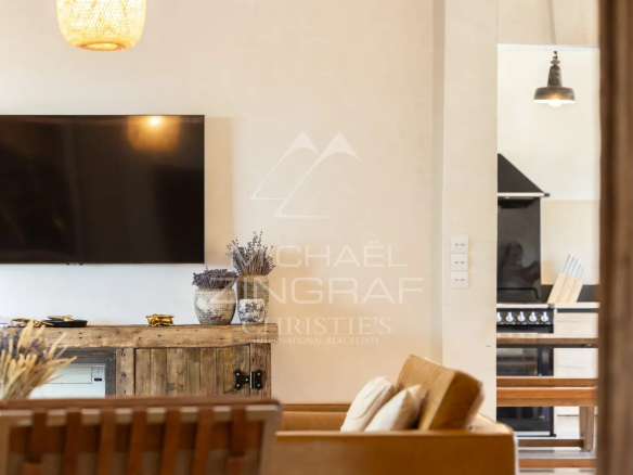 Interior of a Provençal country house with living room and television, elegantly decorated.