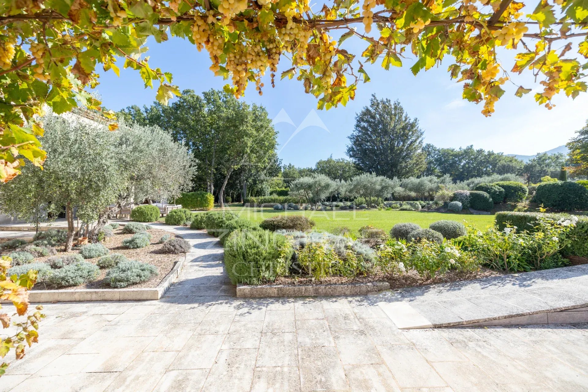 Bastide garden in Ménerbes Landscaped garden of a Provençal bastide in Ménerbes with views of the Luberon.