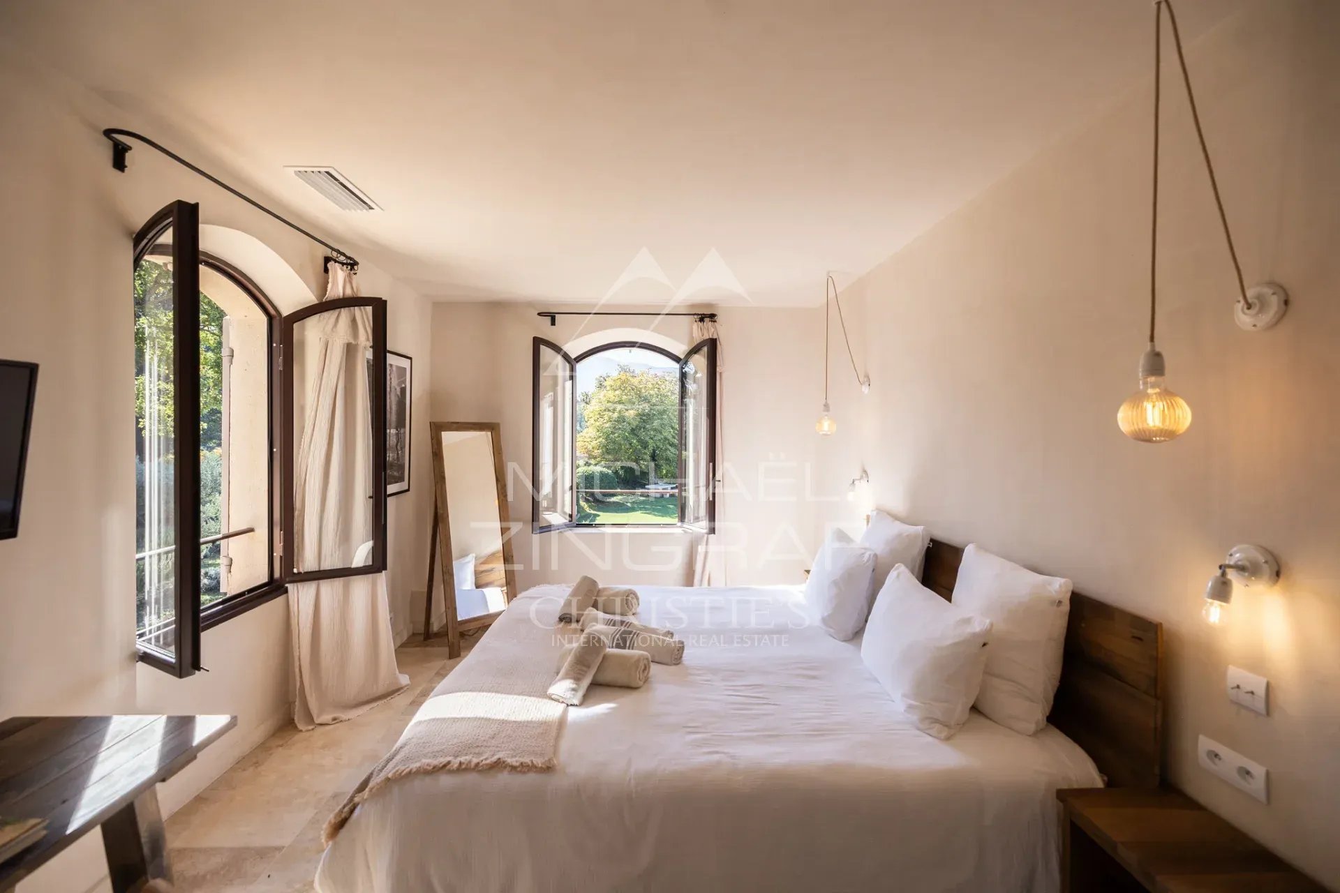 Elegant room in Ménerbes Room in a Provençal country house with open windows and a view of the garden.