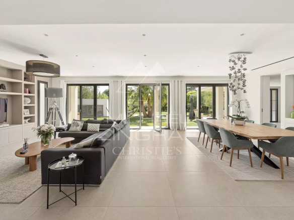 Interior of a contemporary villa in Saint-Paul-de-Vence, bright living room with open kitchen and reception area.