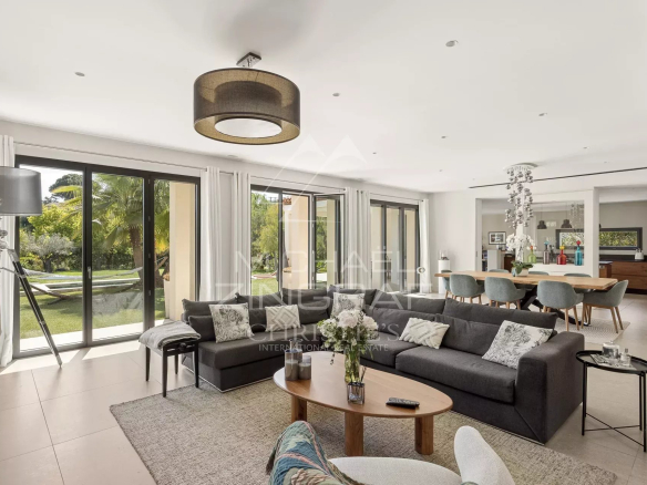 Interior of a contemporary villa in Saint-Paul-de-Vence, spacious and bright living room with open kitchen.
