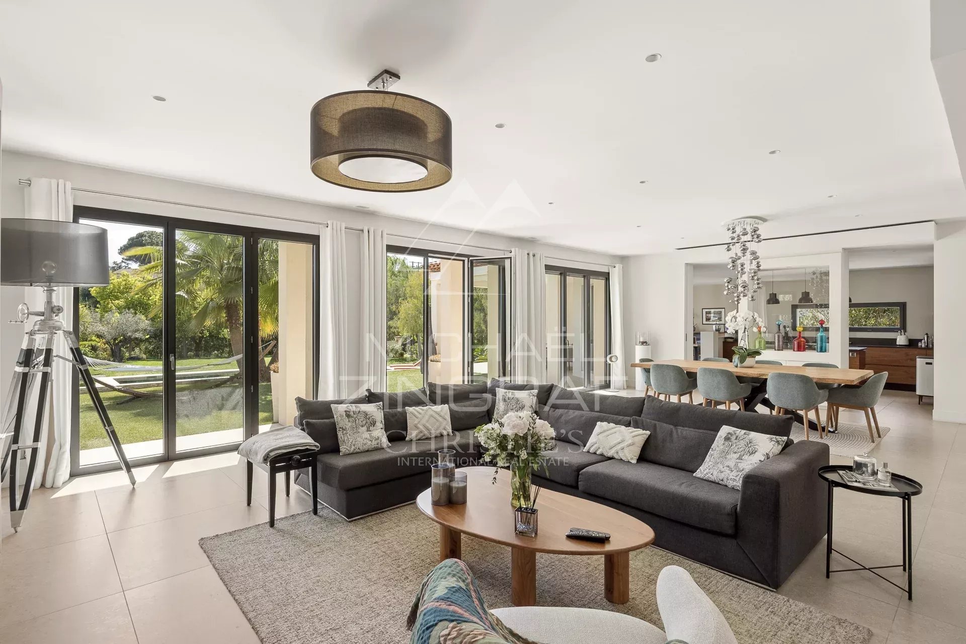 Interior of a contemporary villa in Saint-Paul-de-Vence, spacious and bright living room with open kitchen.