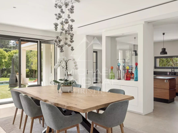 Interior of a contemporary villa with dining room and open kitchen in Saint-Paul-de-Vence.