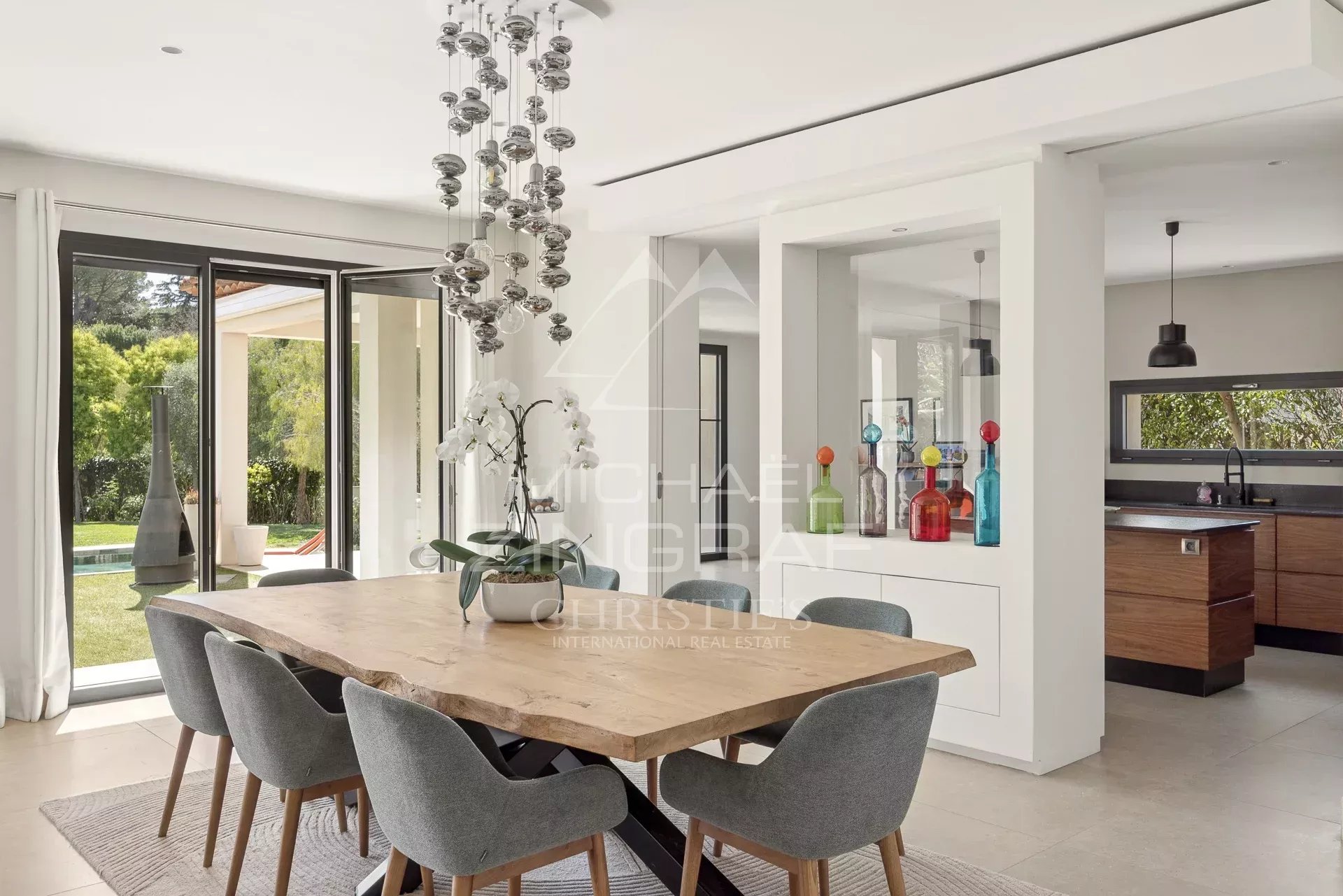Interior of a contemporary villa with dining room and open kitchen in Saint-Paul-de-Vence.