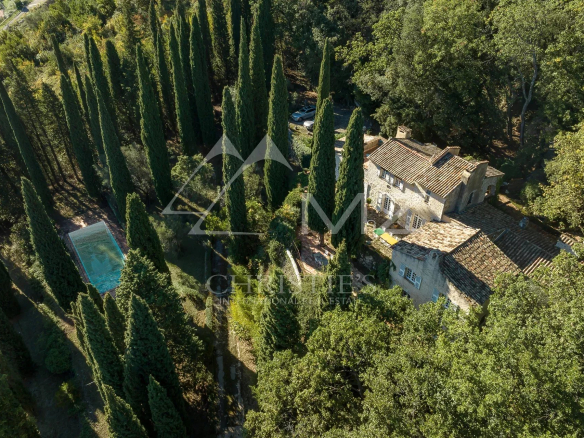 Aerial view of a mansion with swimming pool and wooded park in Tourrettes-sur-Loup.