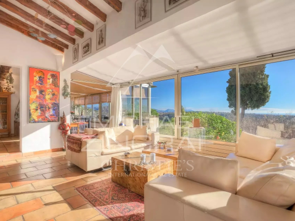 Interior of a Provençal villa in Vence with sea view, bright living room and warm decor.