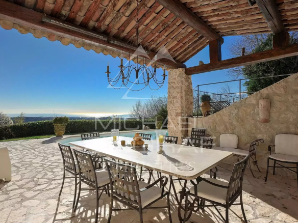 Stone terrace with table and chairs, sea view in Vence.