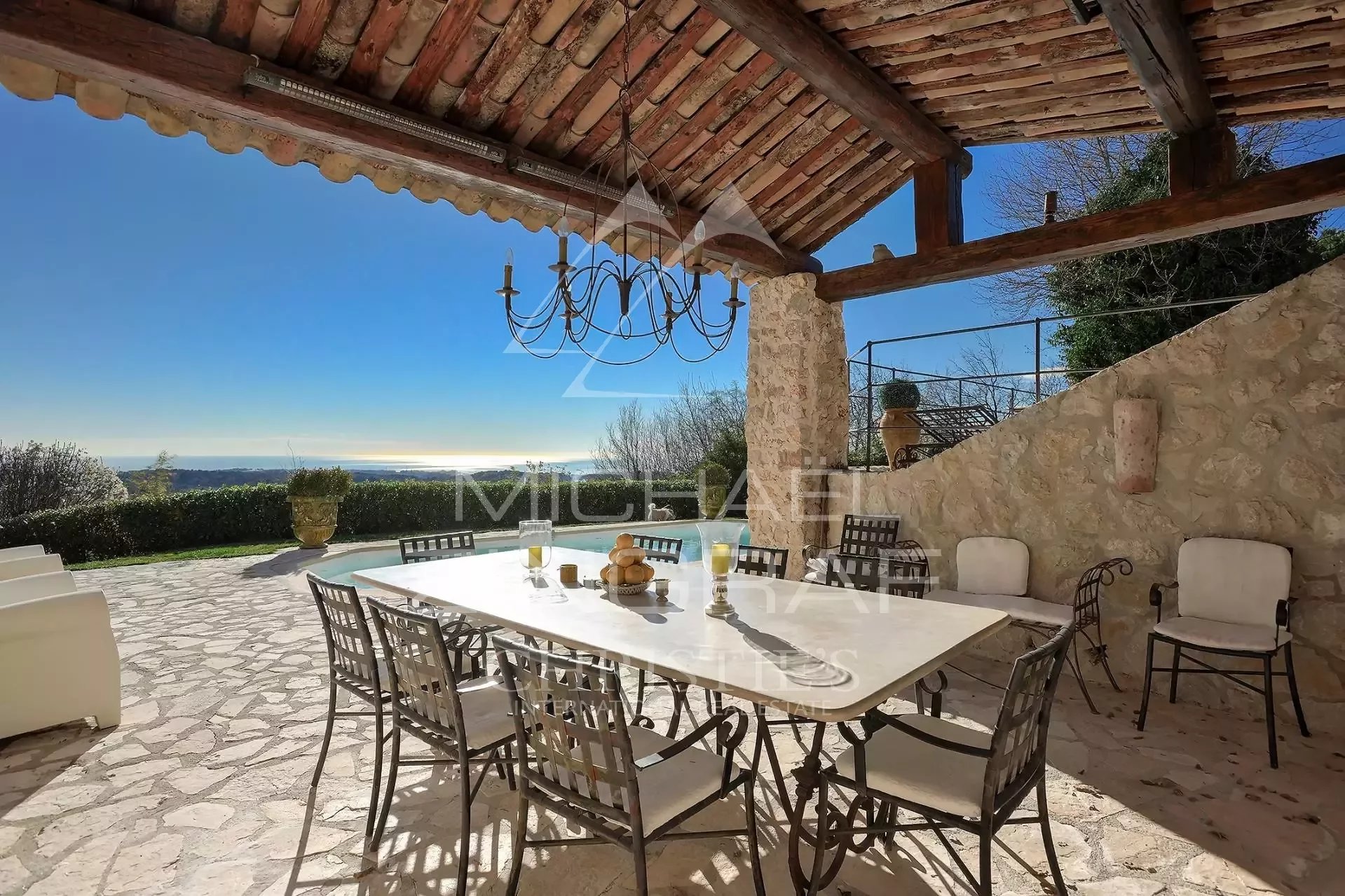 Terrace with panoramic views in Vence Stone terrace with table and chairs, sea view in Vence.