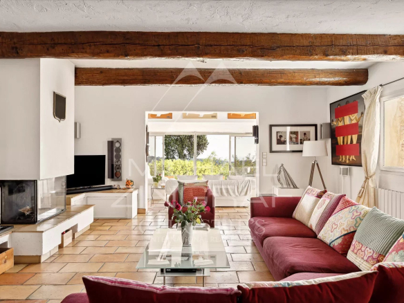 Interior of a Provençal villa in Vence with a bright living room and colorful sofas.