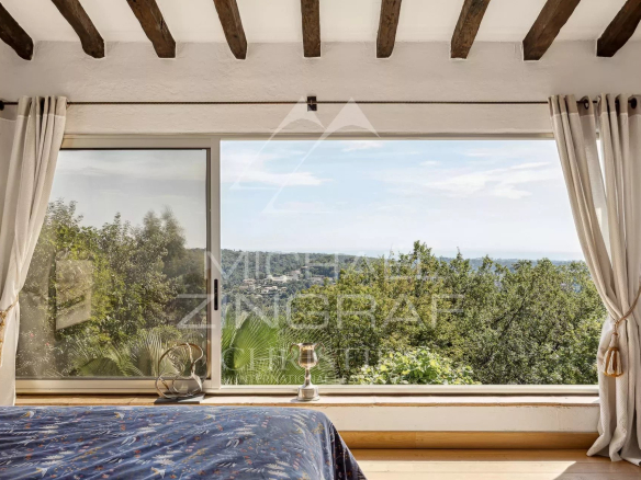 Panoramic sea view from a villa in Vence, with a bright interior and wide open windows.