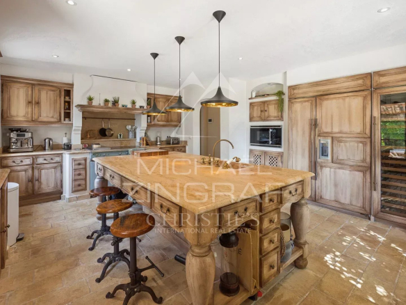 Cuisine spacieuse avec îlot central en bois et meubles en bois clair, éclairage moderne, La Colle-sur-Loup
