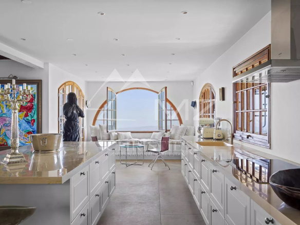 Interior of a Provençal villa with modern kitchen and sea view.