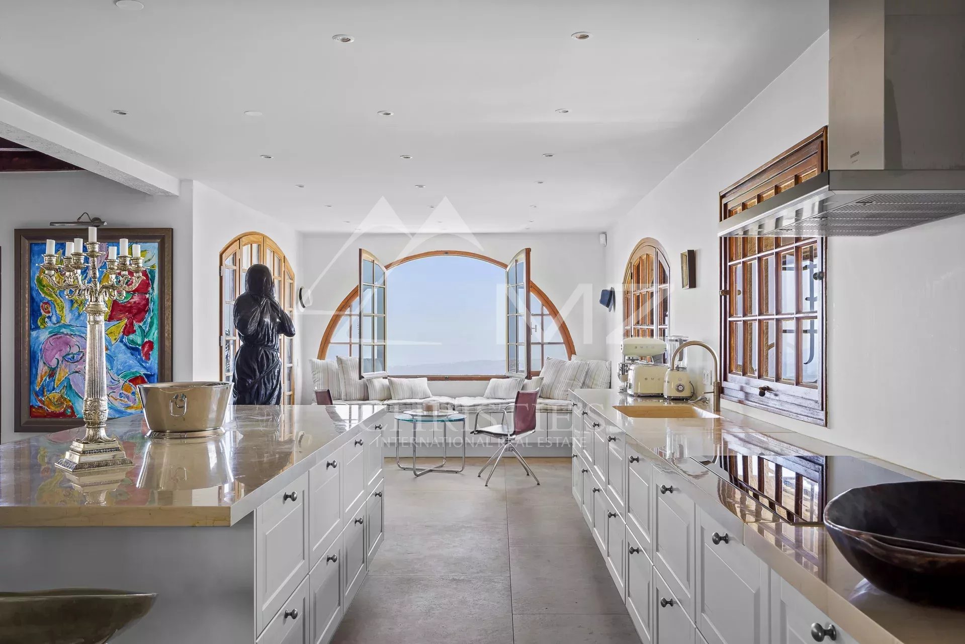 Interior of a Provençal villa with modern kitchen and sea view.