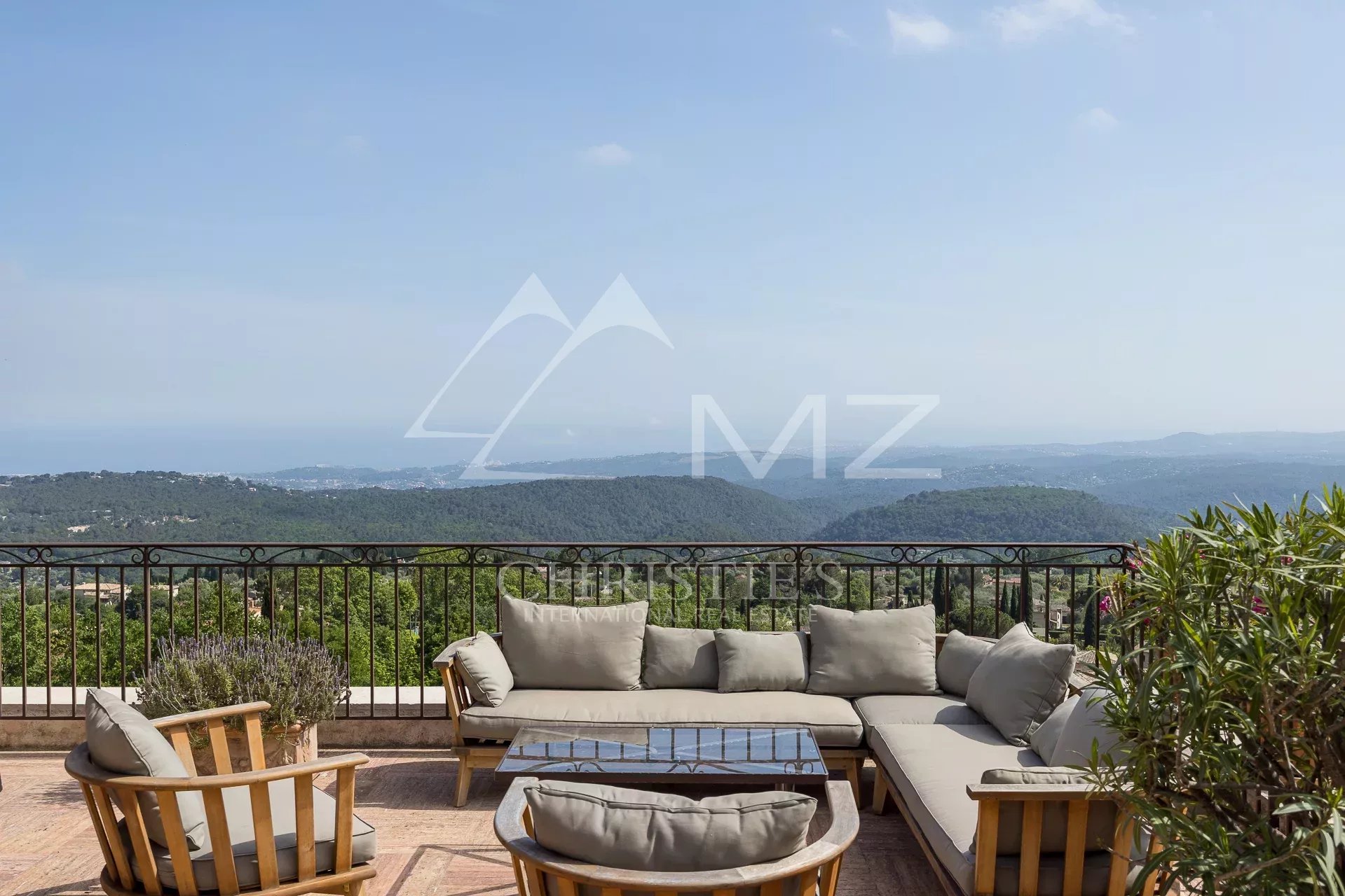 Terrace of a Provençal villa with panoramic views of the sea and hills.