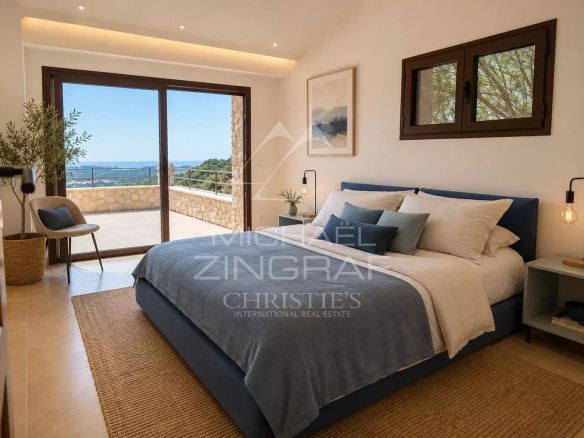 Chambre d'une villa à Saint-Paul-de-Vence avec vue sur la mer et le village.