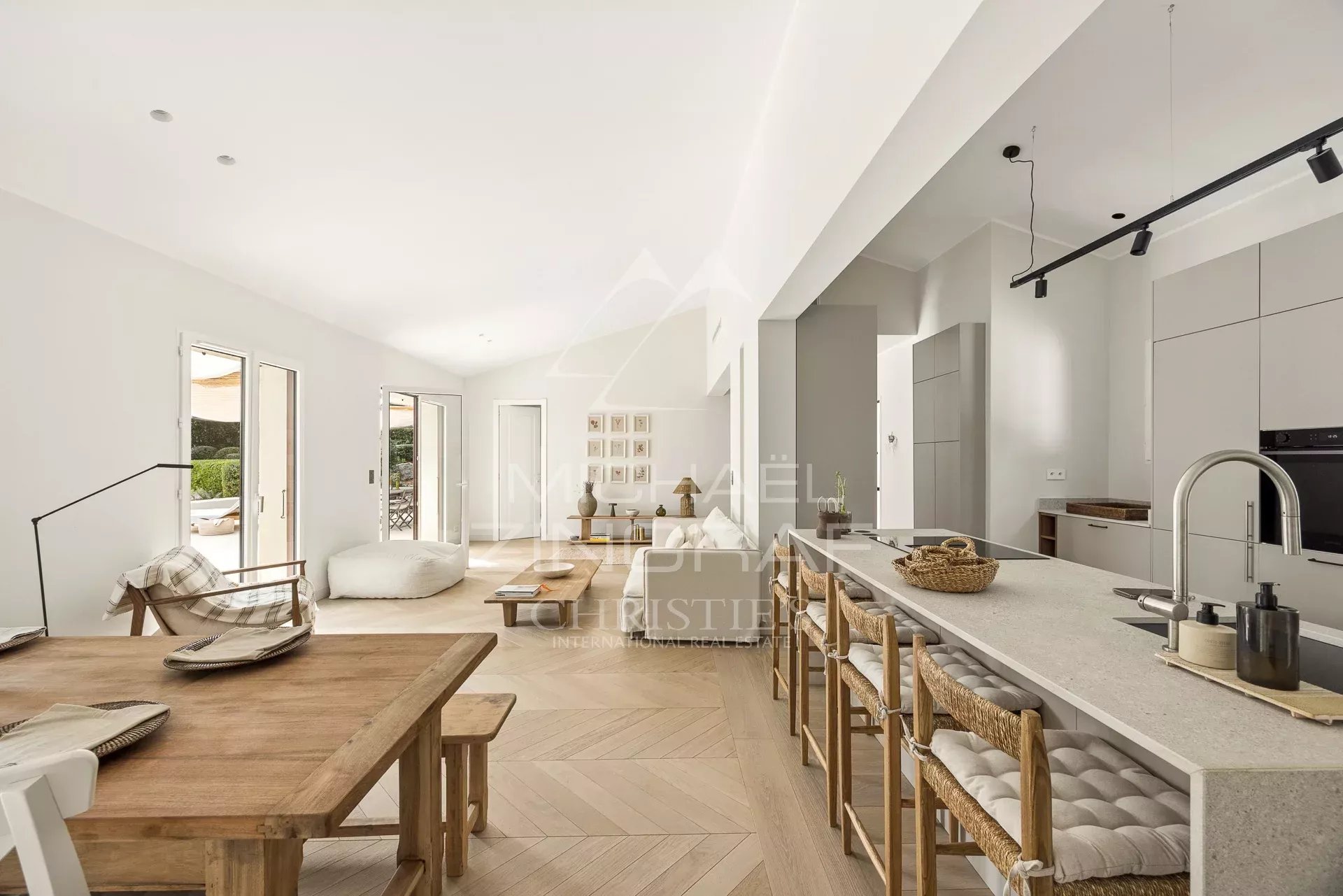 Interior of a renovated villa Interior of a renovated villa with open kitchen and dining room, bright and modern.