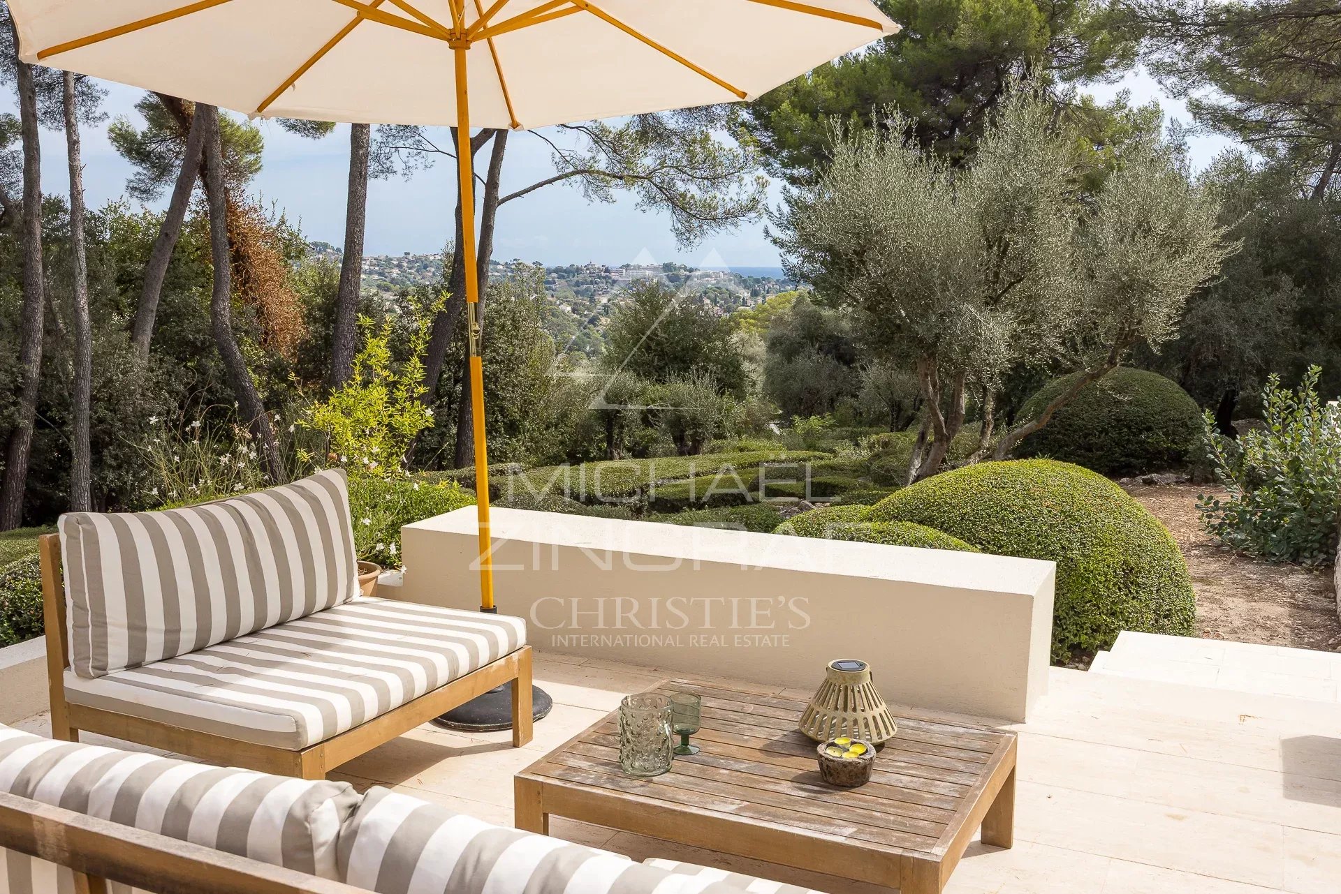 Renovated villa in La Colle-sur-Loup Terrace of a renovated villa with furniture, overlooking a landscaped park in La Colle-sur-Loup.
