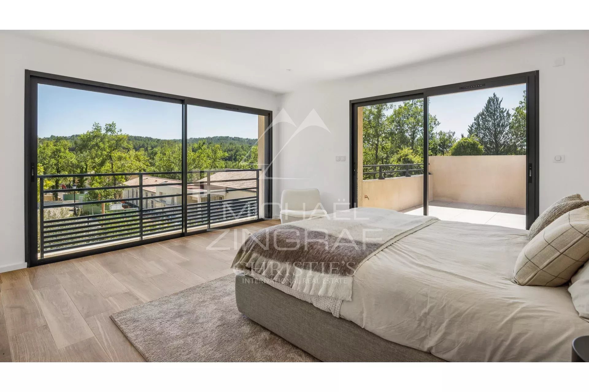 Bright room with views of nature, large bay windows and modern decor.
