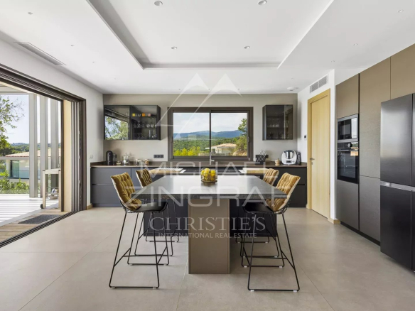 Modern kitchen with central island and valley view in Roquefort-les-Pins.