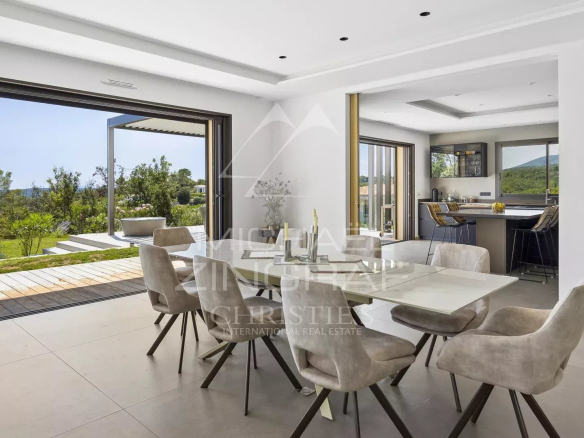 Interior of a contemporary villa in Roquefort-les-Pins with dining room and panoramic view.