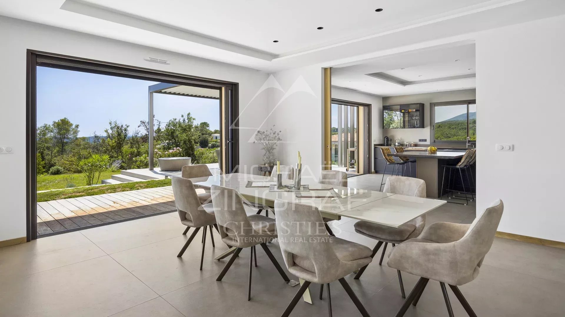 Interior of a contemporary villa in Roquefort-les-Pins with dining room and panoramic view.