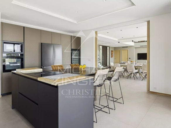 Modern interior of a contemporary villa with open kitchen and bright reception area in Roquefort-les-Pins.