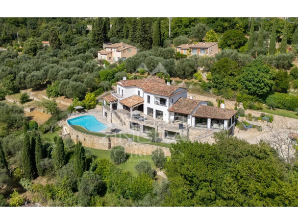 Vue aérienne d'une villa contemporaine avec piscine et jardin à Grasse, entourée de collines.