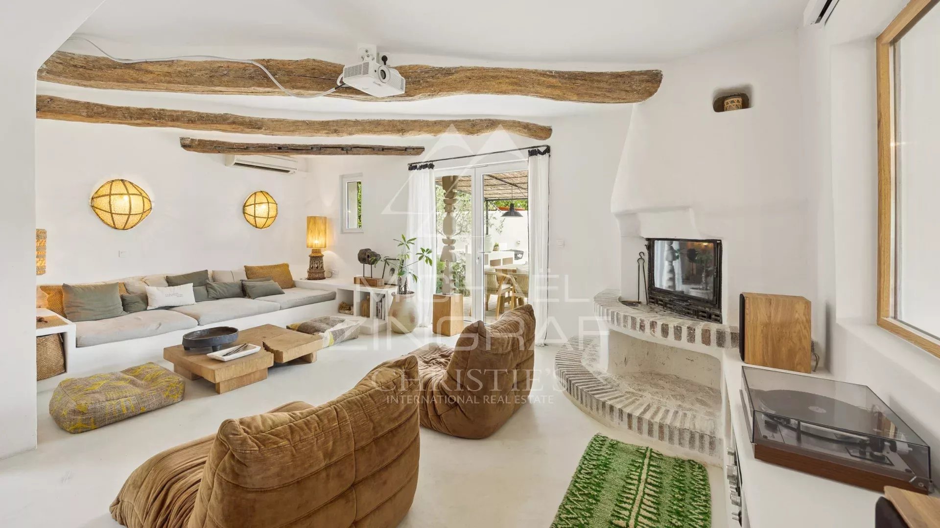 Living room of a villa in Le Rouret Interior of a Mediterranean villa with a bright living room and fireplace