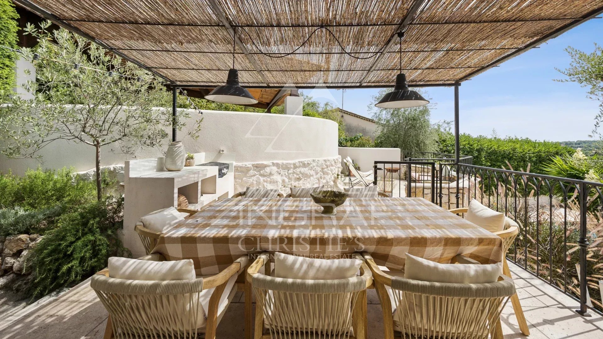 Mediterranean terrace in Le Rouret Sunny terrace with dining table and chairs, surrounded by greenery, in Le Rouret.