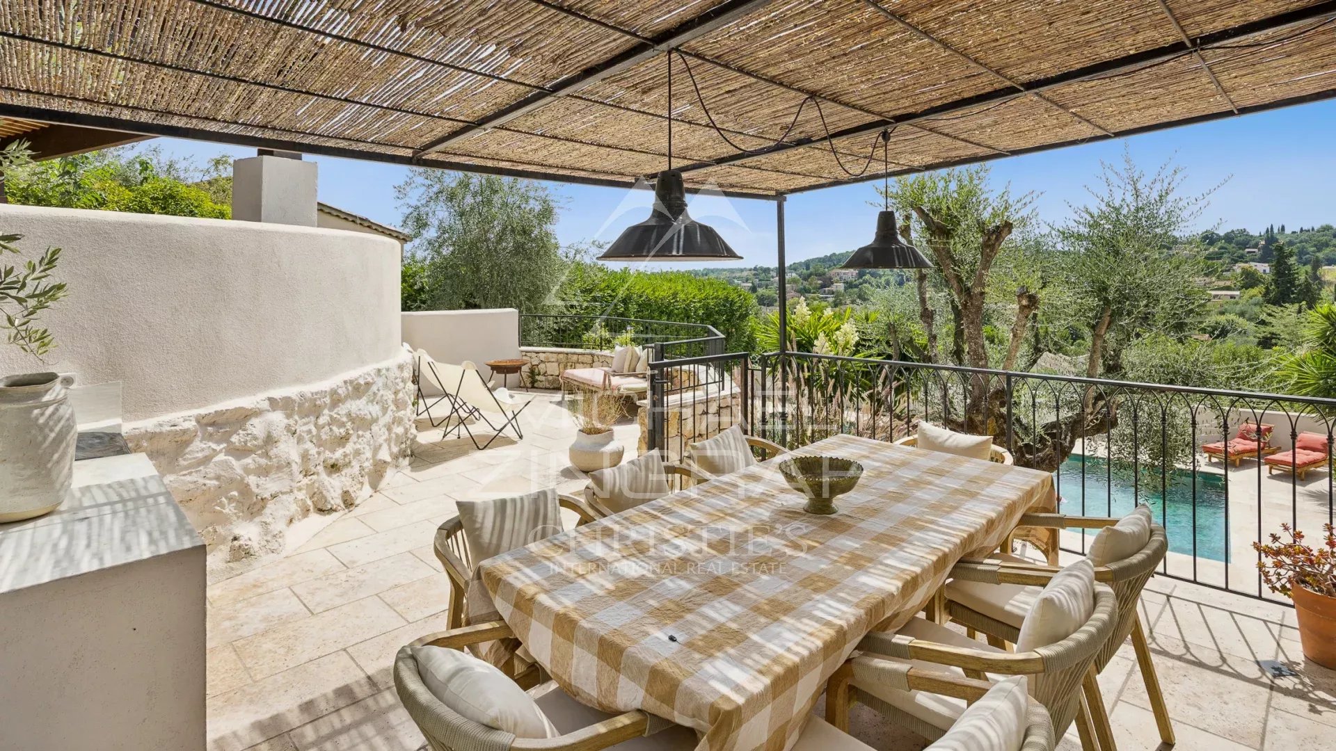 Mediterranean terrace in Le Rouret Terrace of a villa in Le Rouret with views of the hills, wooden furniture and dining table.