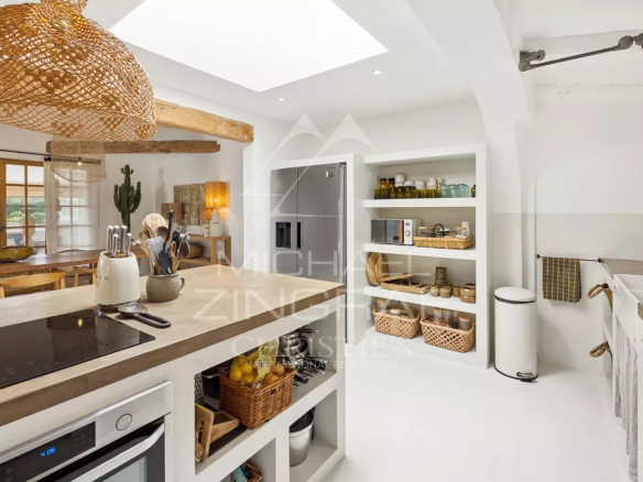 Interior of a modern and bright kitchen with an open living space.