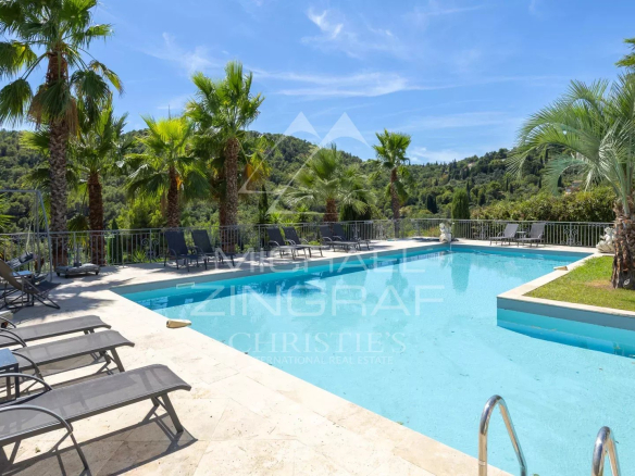 Piscine et jardin paysager d'une villa contemporaine à Grasse avec vue sur les collines.