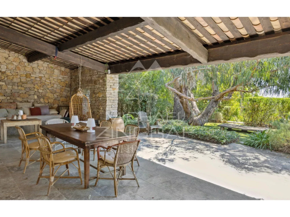 Terrace of a Mediterranean villa with wooden furniture and plants, Châteauneuf-Grasse.